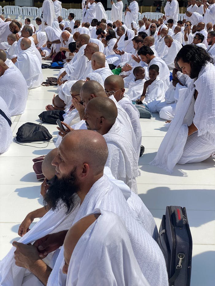 A gathering of worshippers in white attire during Hajj in Mecca, Saudi Arabia.
