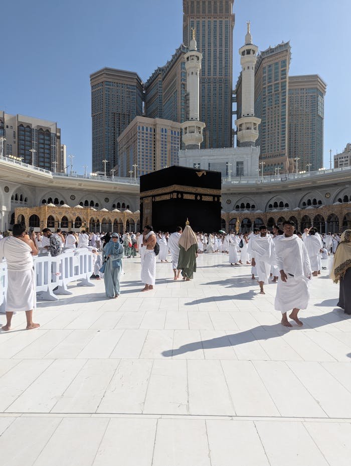 Pilgrims gather in traditional attire around the Kaaba in Mecca, Saudi Arabia, during Hajj.