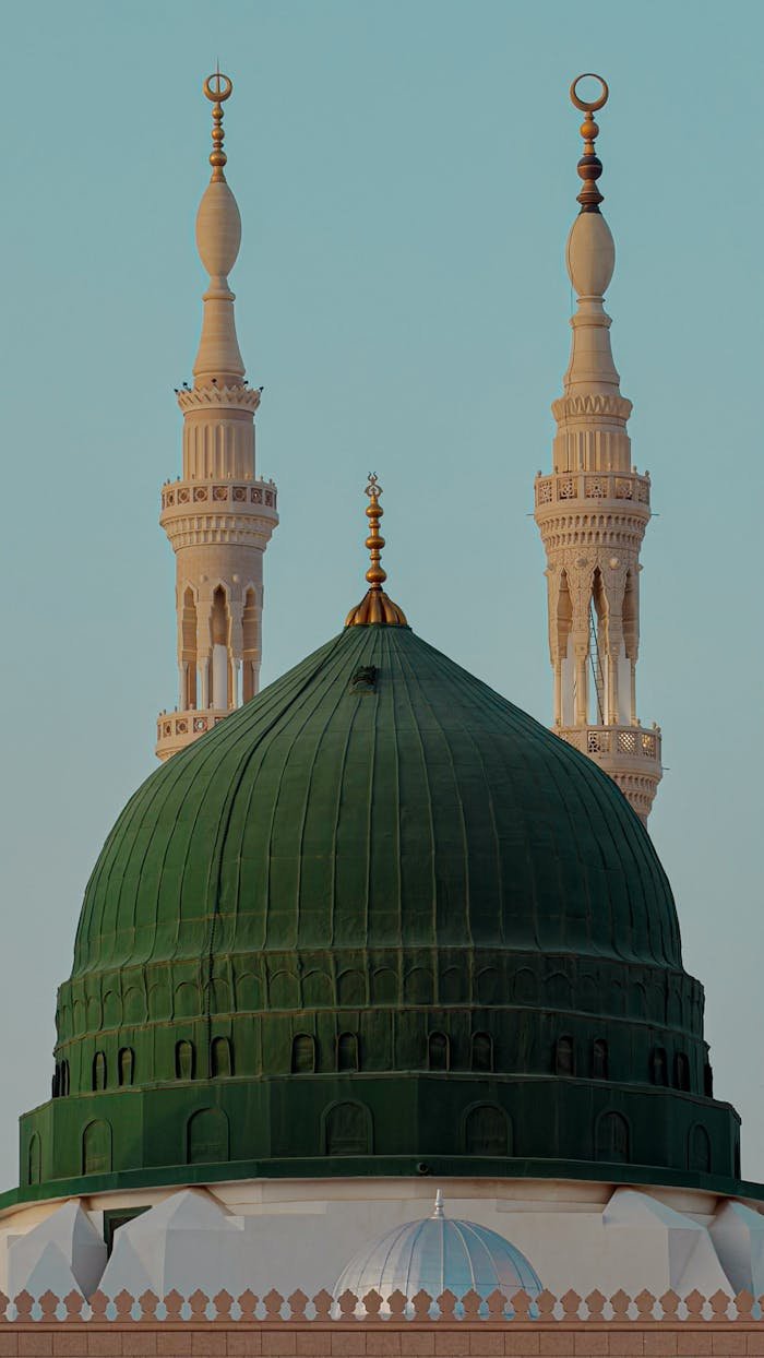 Close-up of the iconic Green Dome and Minarets of the Prophet's Mosque in Medina.